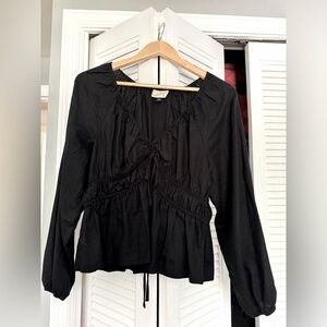 Black peplum shirt, very cute.